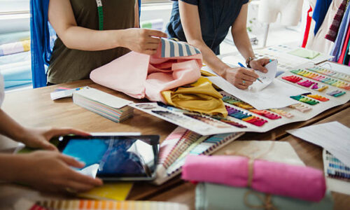 Three female workers meeting in Fashion design studio.